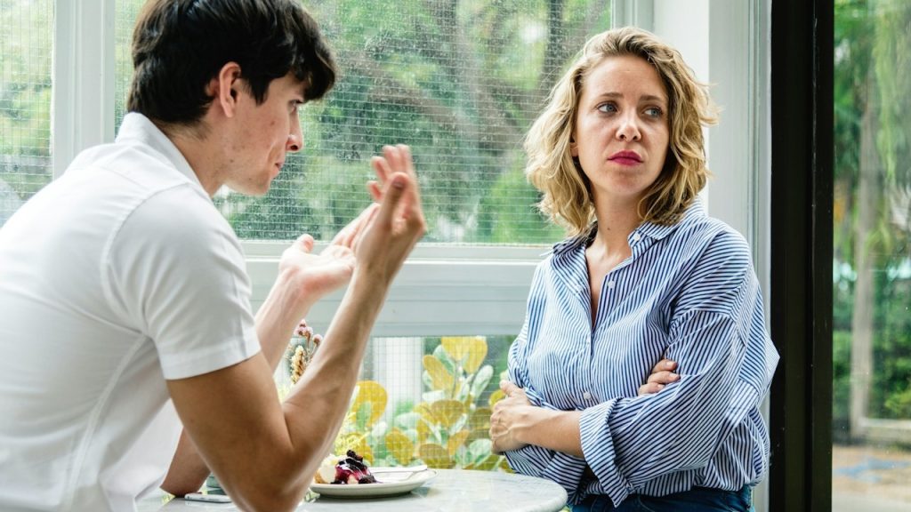 A man explaining something to his angry girlfriend.