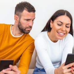 Jealous boyfriend spying on his girlfriend's phone.