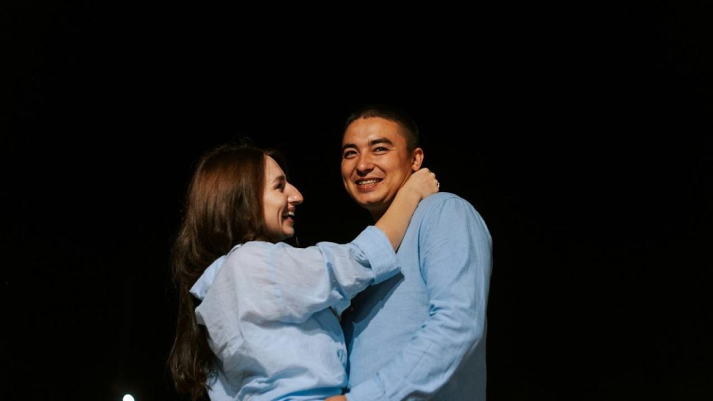 A man and a woman hugging each other.