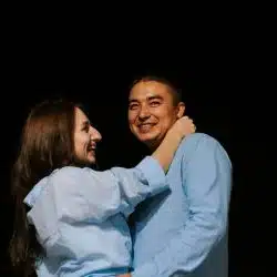 A man and a woman hugging each other.