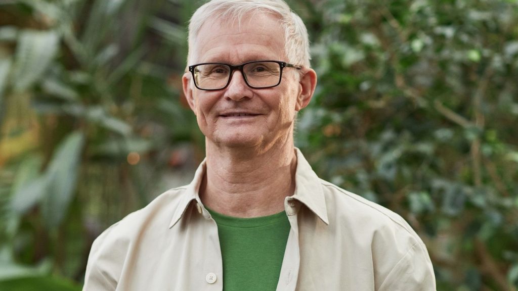 A man wearing eyeglasses while looking at the camera.