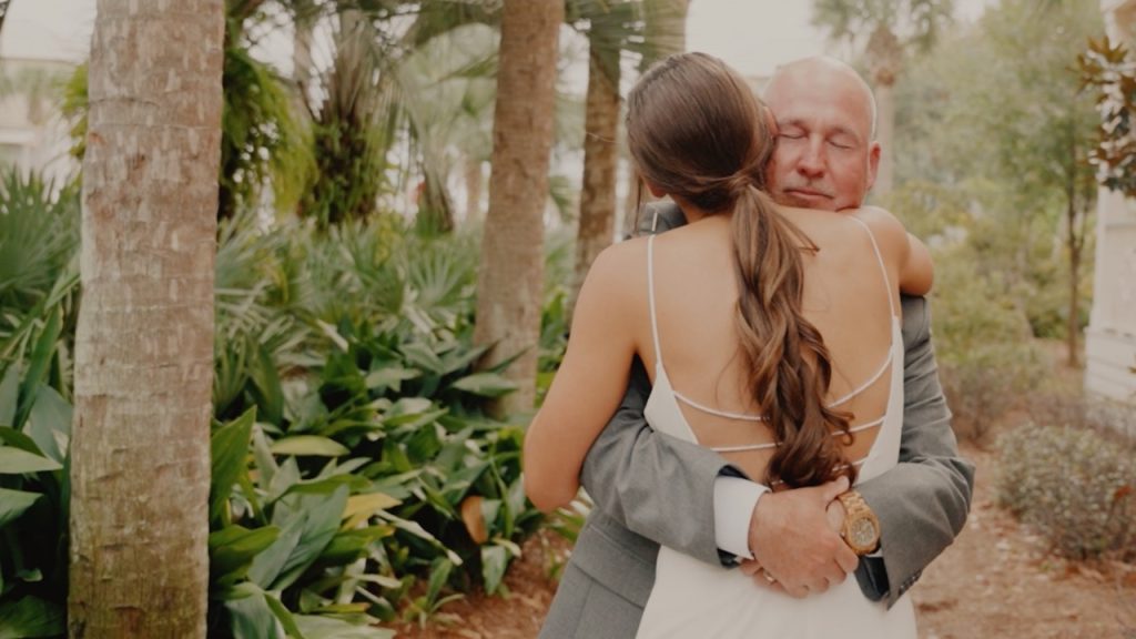 An old man is hugging a young lady.