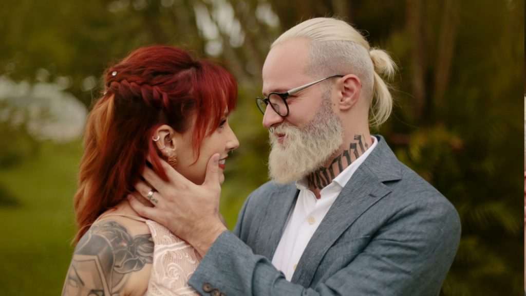 An old man and a young lady are embracing each other.
