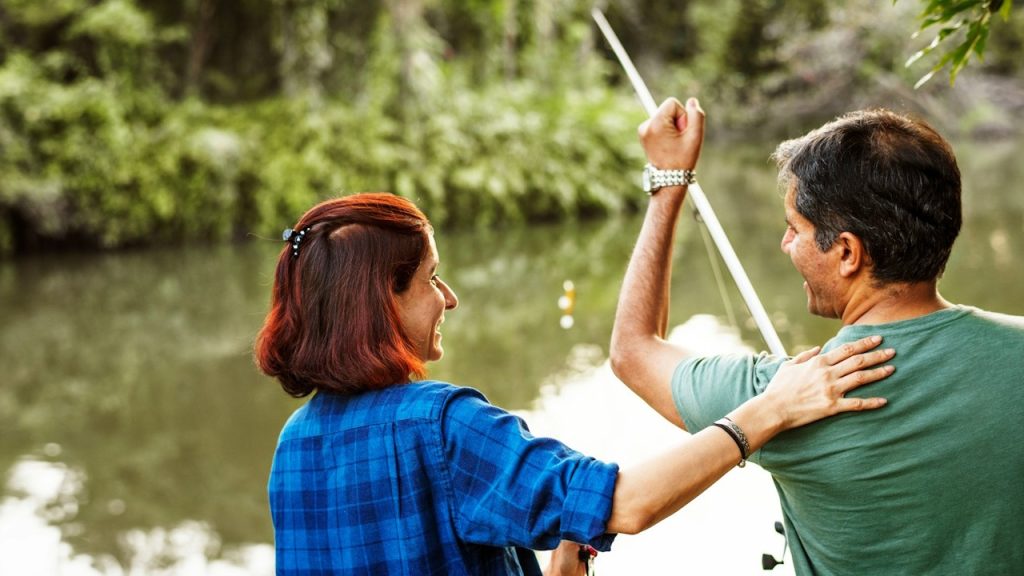 A couple fishing together.