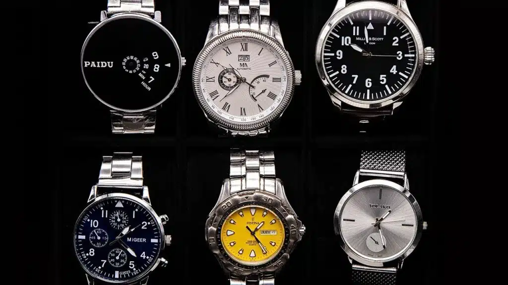 Silver watches on a black background.