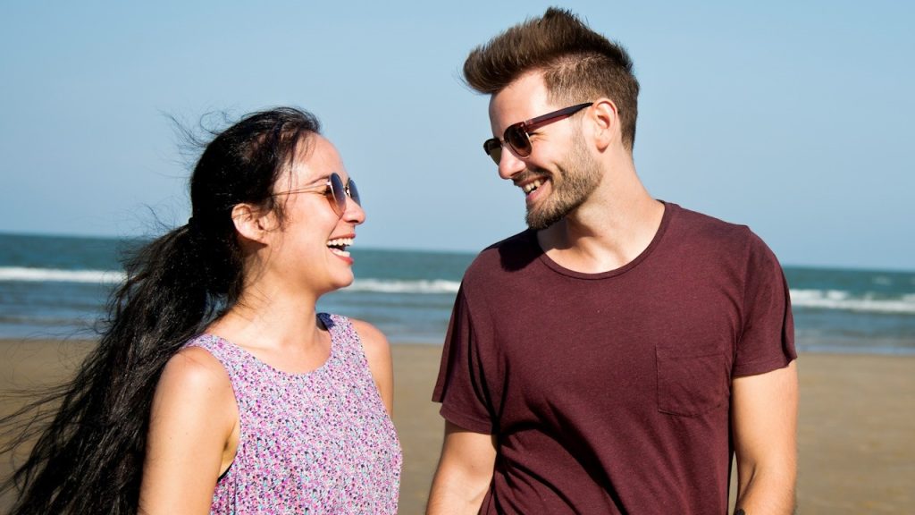 A couple enjoying each other's company at a beach.