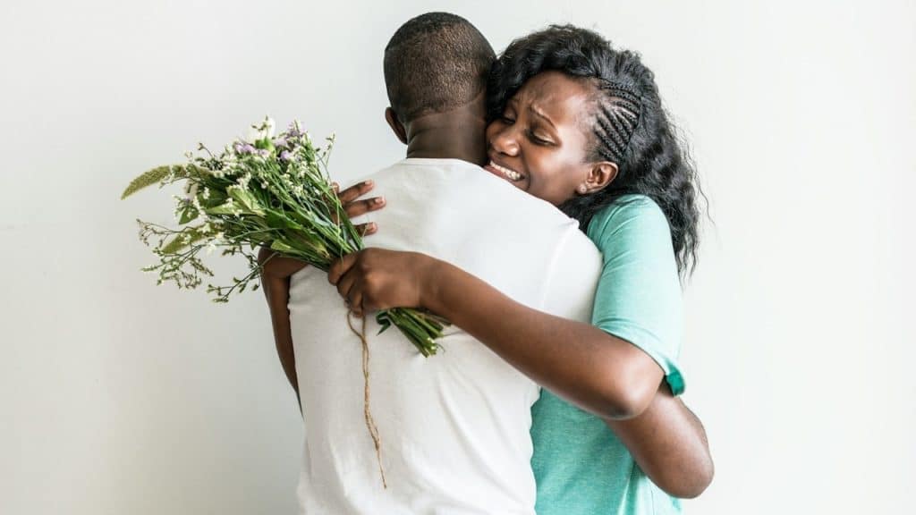 The wife receives a bouquet of flowers from her husband.