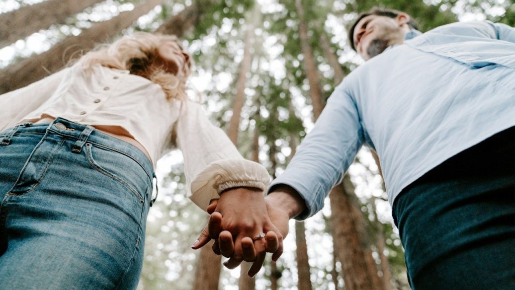 A man and a woman holding each other's hand.