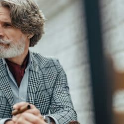 Handsome bearded gentleman looking away with a serious expression.