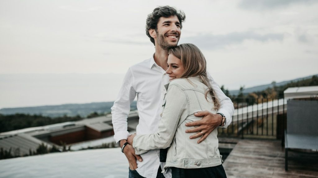 Man and woman hugging each other.