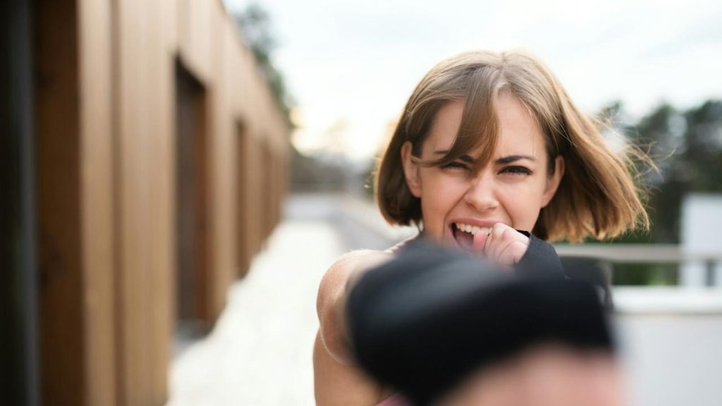 A woman screaming outdoors.