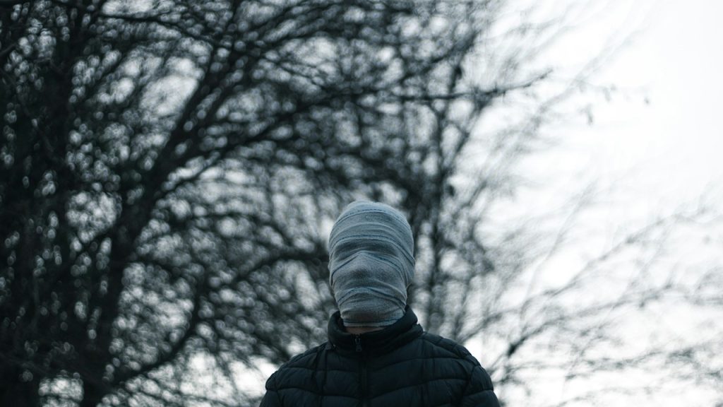 A man covered his face with a mask.