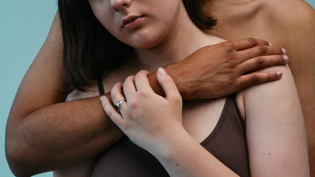 A man and woman embracing each other.