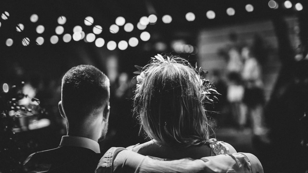 Grayscale image of a couple sitting together.