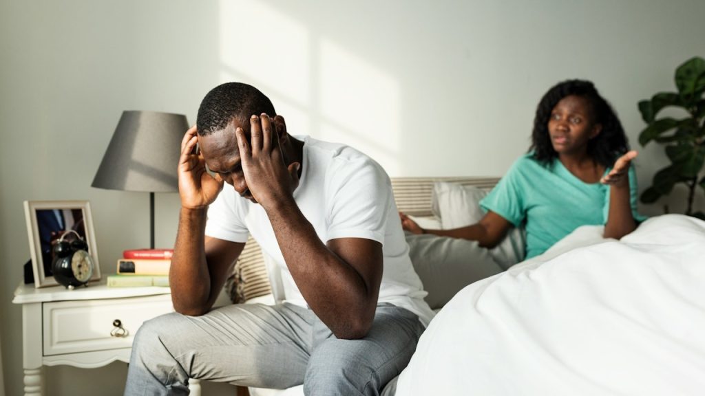 A couple having an argument in the bed.
