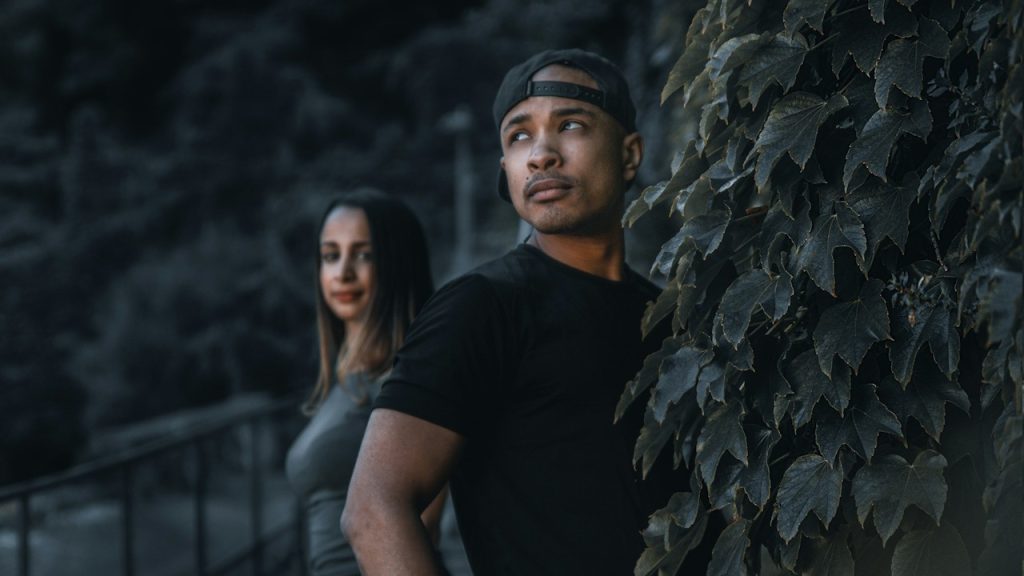 A couple standing in nature at dusk.