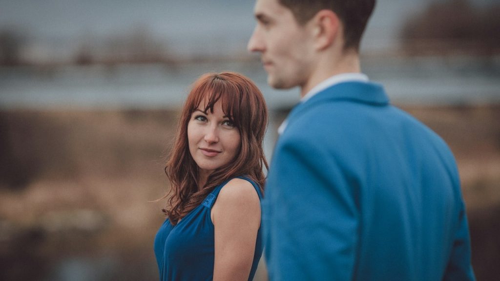 A man and woman looking at each other.