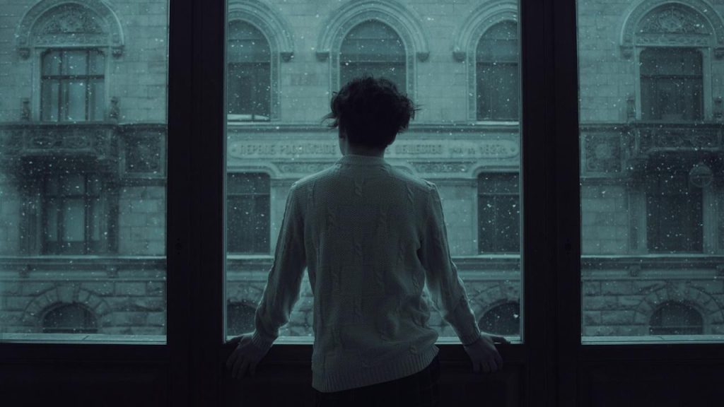 A man gazing out of a window.