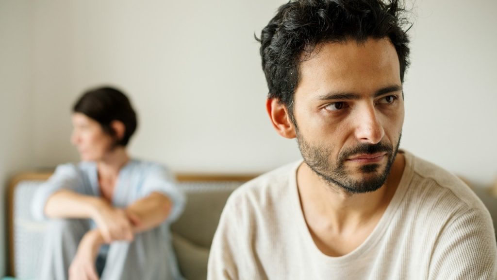 A man and a woman are sitting, upset after having an argument.