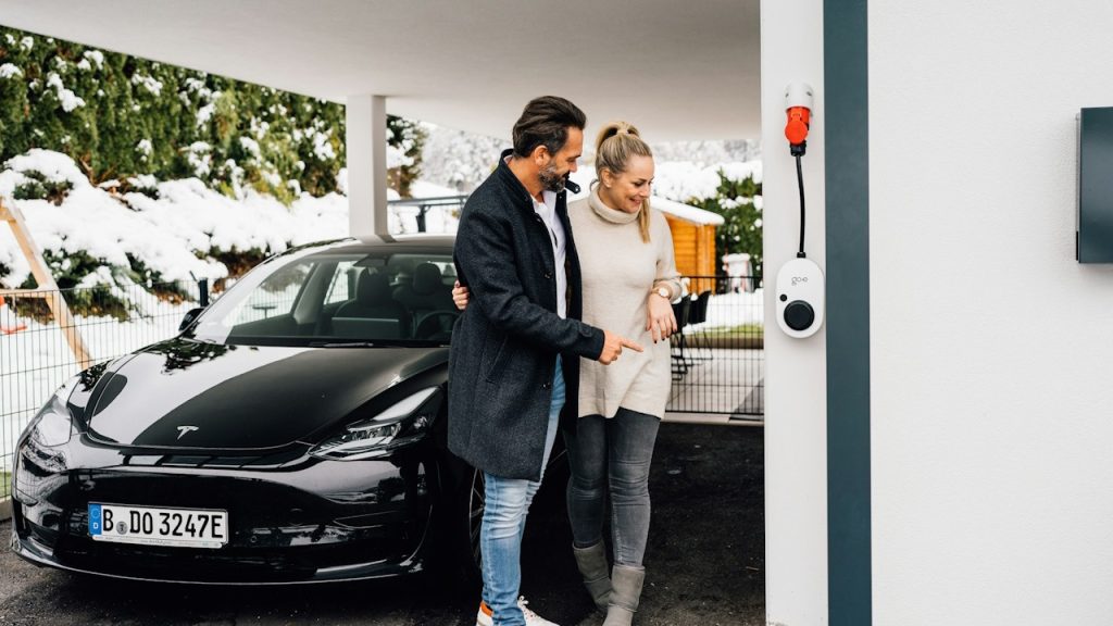 A couple standing in the garage of their new home.