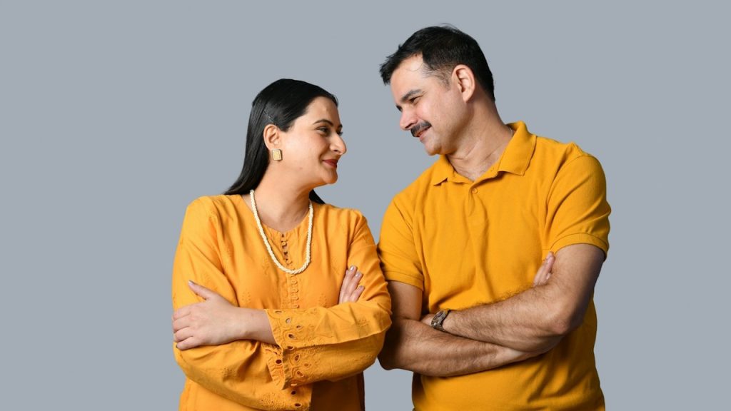 A man and a woman standing next to each other and smiling.