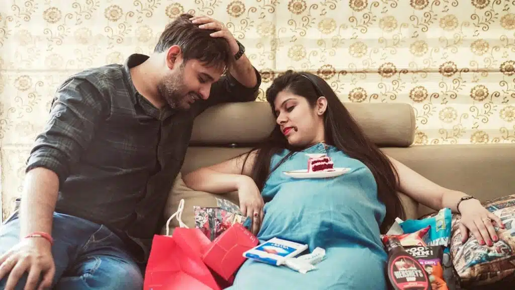 A man and a woman sitting on a couch together.