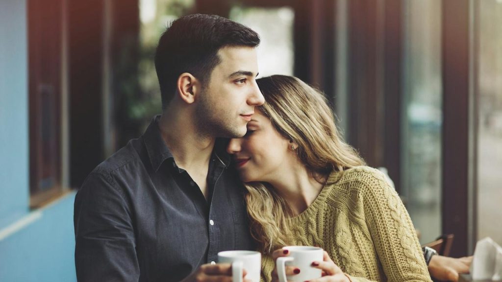 A couple in love drinking coffee and having fun in coffee shop love.