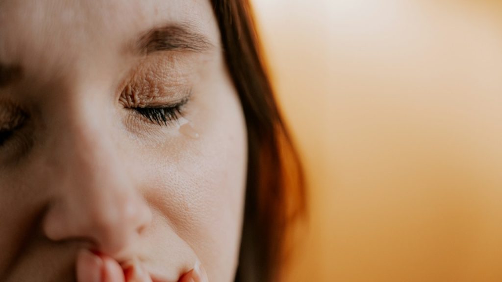 Closeup of a woman with her eyes closed.