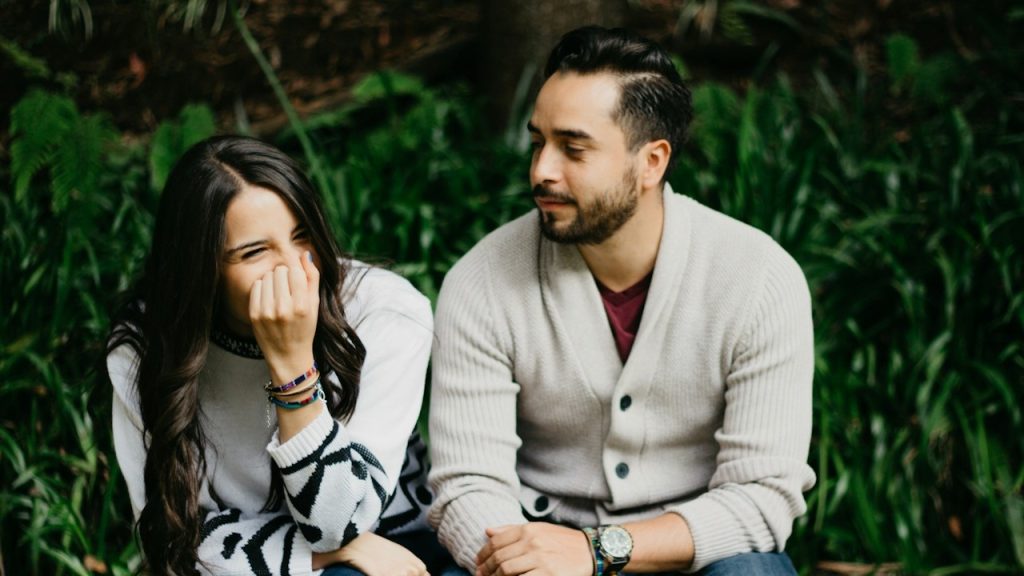 A man sitting beside a smiling woman.
