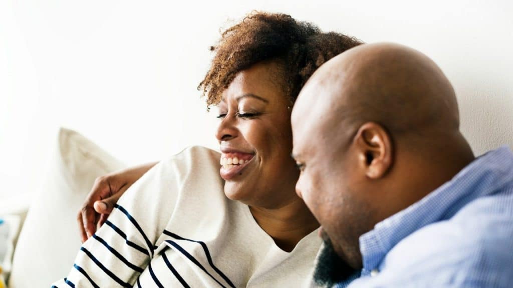 Happy couple relaxing at home.