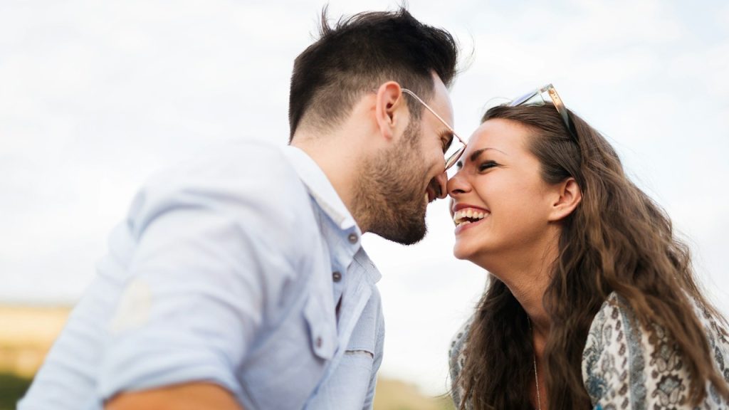 An attractive couple on a romantic date by the river.