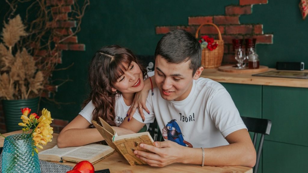 A man in a white crew-neck t-shirt beside a woman in a white crew-neck t-shirt.