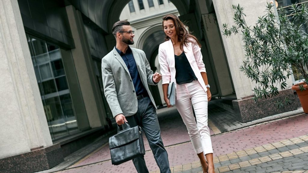 A couple in professional attire walking together.