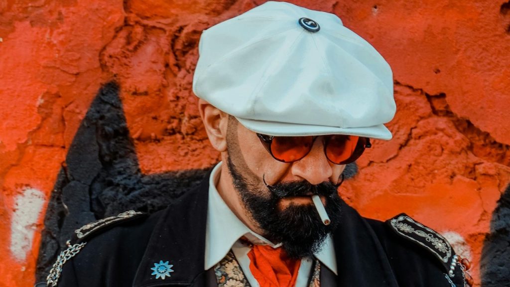 A man in old-fashioned clothing smoking a cigarette