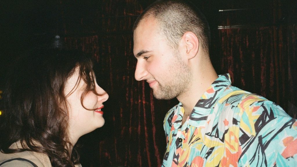 A man and a woman standing next to each other.