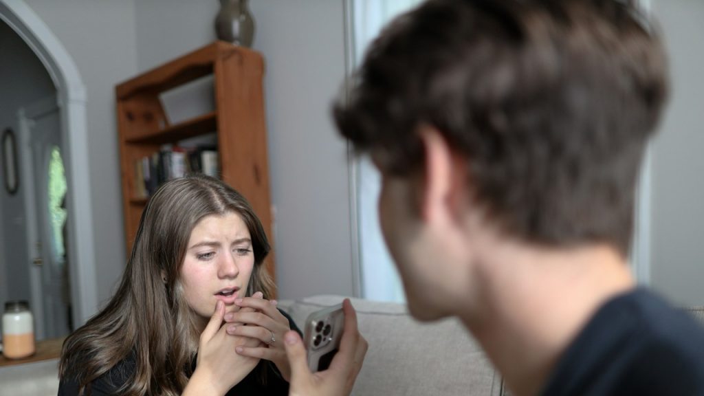 A boy showing The mobile to the girl