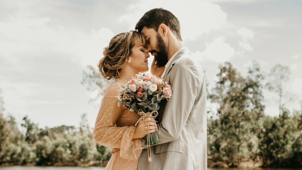 A couple standing on a dock.