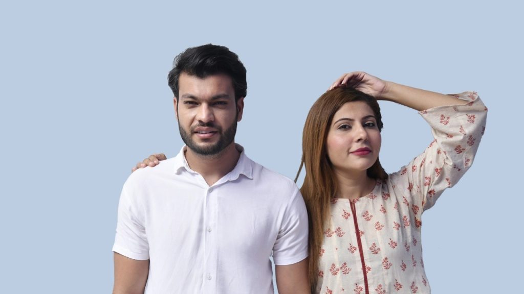 A man and woman posing for a picture.