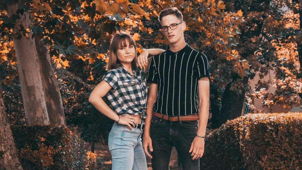 A couple standing on a concrete stair.