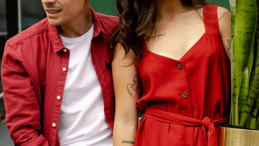 A man and a woman wearing red dresses.