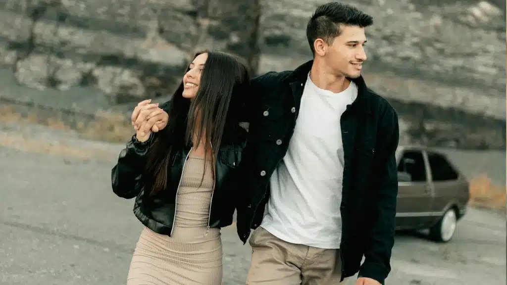 A man and a woman walking down a road.
