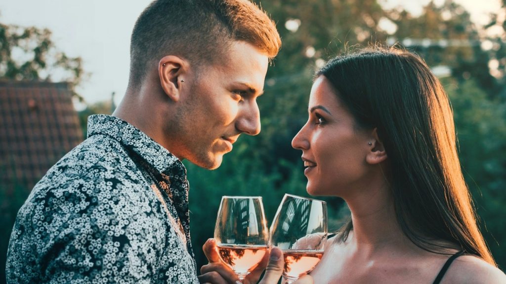 A man and woman holding wine glasses.