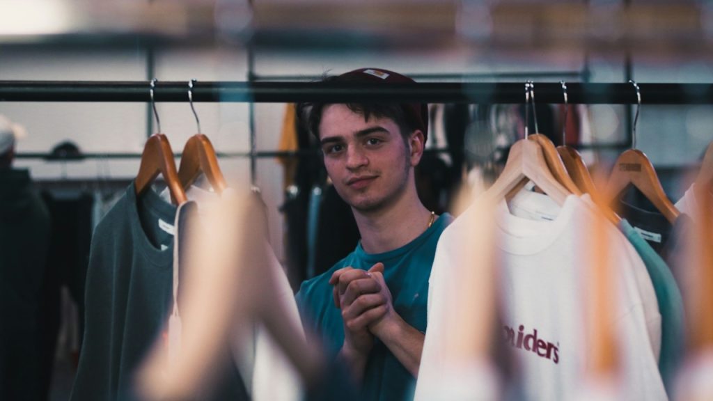 A man looking in his wardrobe and rubbing his hands.