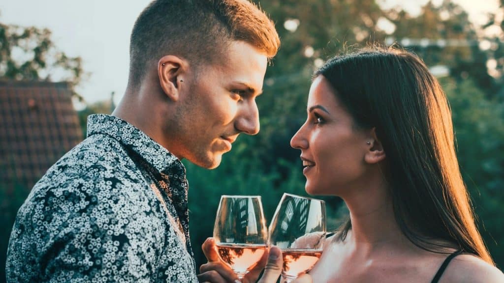 A man and woman holding wine glasses.