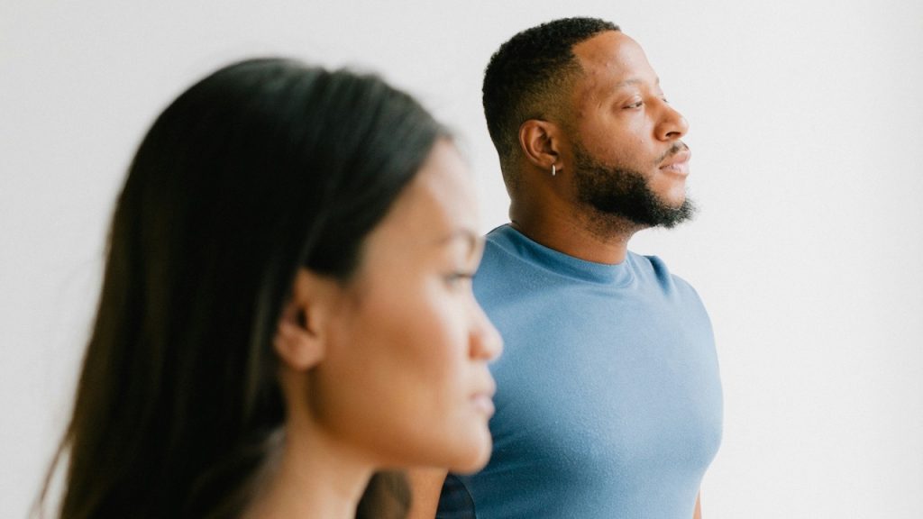 A nonchalant couple gazes off to one side.