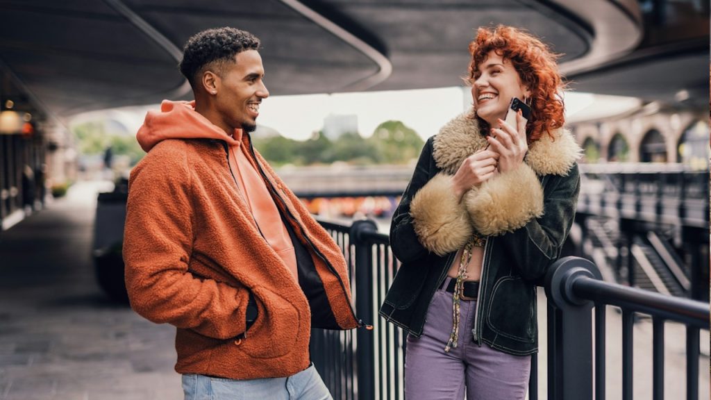A man and woman standing on a station.
