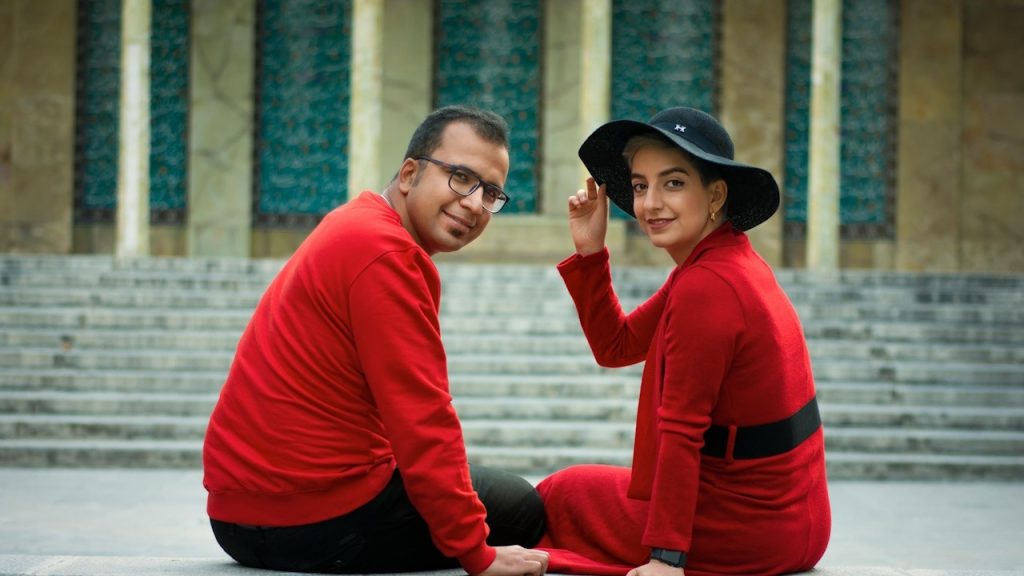 A man-in-red-and-black long-sleeve shirt and a black hat.
