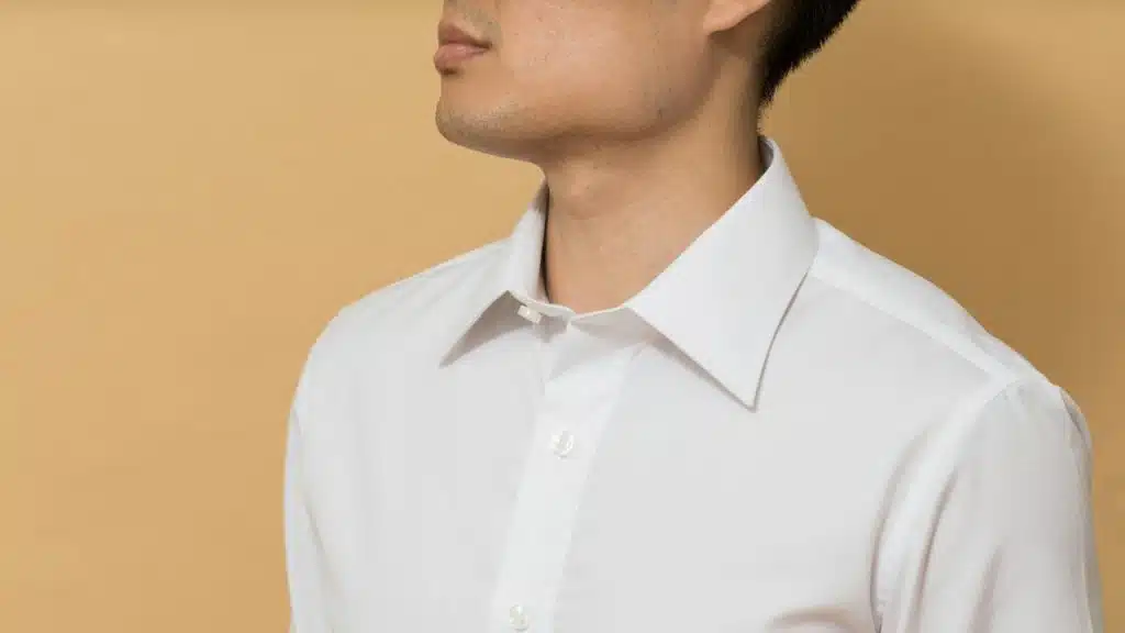 A man wearing a white shirt.