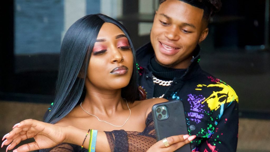 A man and a woman taking a selfie while standing next to each other.