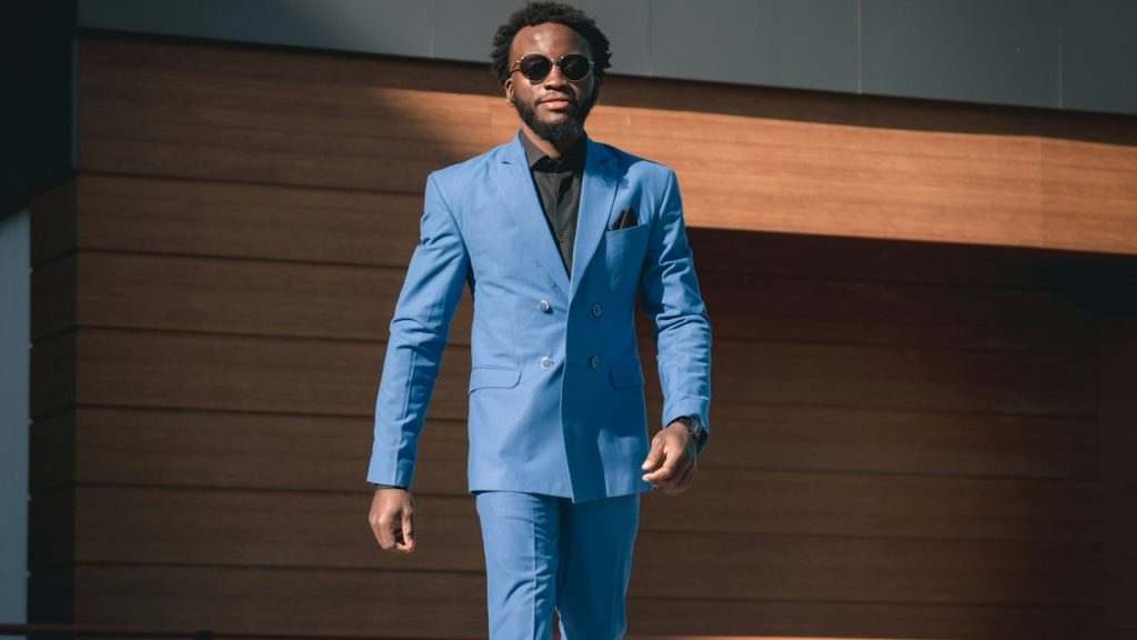 A man-in-a-blue-suit-walking-down-a-street.